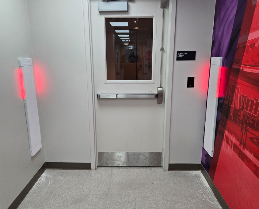 Assettrack With Red Lights Next To Exit Door