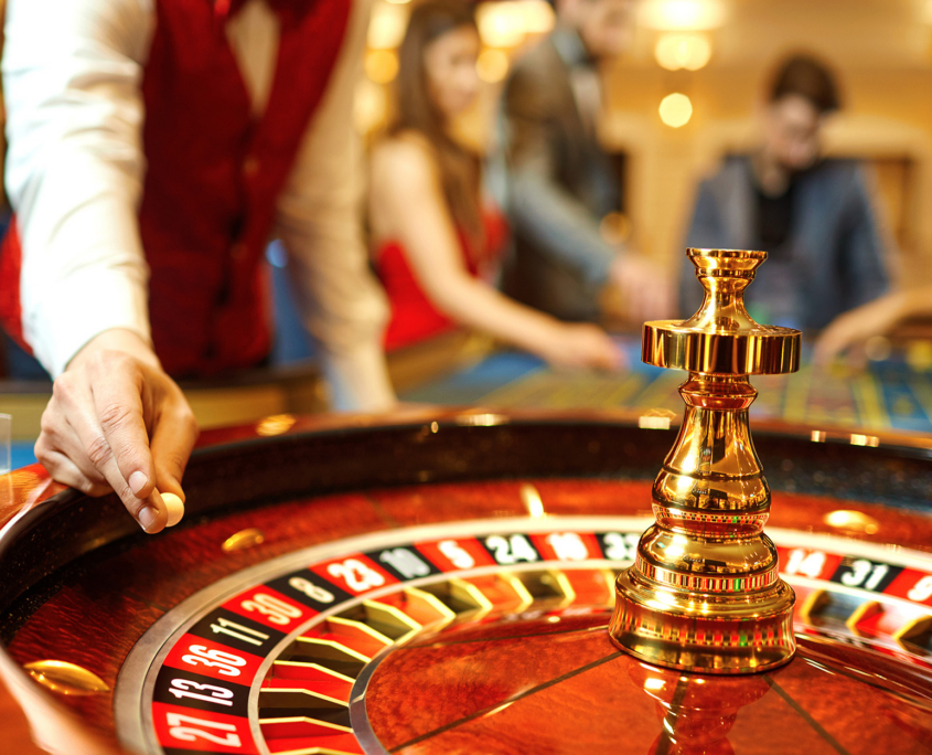Closeup Of Dealer Throwing Marble In Roulette Table